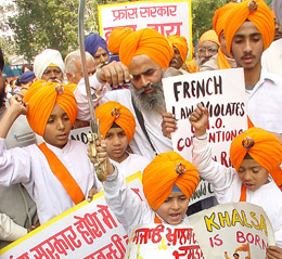 Sikh children shout anti-French government slogans against a law banning the wearing of religious symbols in schools, during a demonstration at Jantar Mantar in New Delhi on Saturday.