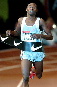Bernard Lagat of Kenya breasts the tape to win the Wanamaker Mile at the 98th Millrose Games in Madison Square Garden on Friday