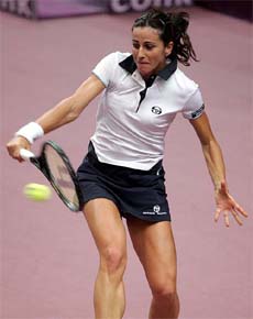 Silvia Farina Elia of Italy returns a backhand to Virginie Razzano of France