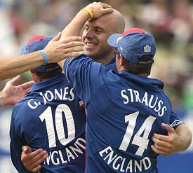 England's bowler Alex Wharf with teammates wicket-keeper Geraint Jones and Andrew Strauss celebrates the dismissal of South Africa's captain