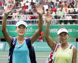 Zi Yan-Jie Zheng of China wave out to the crowd at the WTA Hyderabad Tennis tournament