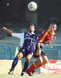 East Bengal striker Baichung Bhutia and Tollygunge Agragami defender Amitava Chandra pushing each other to take control of the ball during the National Football League
