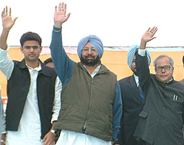 Mr Pranab Mukherjee, Defence Minister, Capt Amarinder Singh and Mr Sachin Pilot, MP, wave to the crowd at a rally in Ajnala on Sunday. 