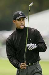 Tiger Woods reacts to his approach from the ninth fairway as he resumes the second round of the Nissan Open at Riviera Country Club in Los Angeles