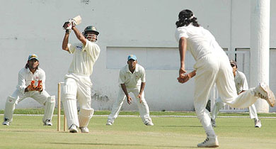 Abdur Razzak of Bangladesh Cricket Board XI hits a boundary to Ranadev Bose of East Zone during the Duleep Trophy match in Nagpur