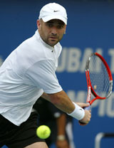 Andre Agassi of the USA prepares to hit a backhand return during his match with Russian Nikolay Davydenko in the quarterfinals of the Dubai Tennis Championships on Saturda