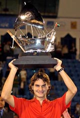 Switzerland's Roger Federer holds the trophy after beating Croatia's Ivan Ljubicic in the final of the Dubai Open 