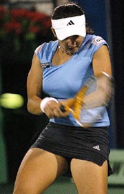 Sania Mirza returns the ball to Svetlana Kuznetsova of Russia during their second round match at the Dubai Open tennis tournament on Tuesday. Sania won 6-4, 6-2. 