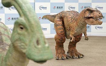 Dinosaur robots walk during a press preview in Tokyo on Friday. 
