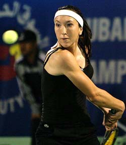 Jelena Jankovic of Serbia returns a ball to Serena Williams of the US