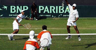 India�s Leander Paes hits a return as team-mate Mahesh Bhupathi looks on during their Davis Cup doubles tie against China�s Wang Yu and Zhu Beng-Qiang in New Delhi on Saturday
