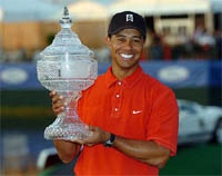 US golfer Tiger Woods poses with the trophy after winning the Doral Open in Toronto on Sunday