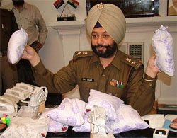 Mr R.P.S. Brar, SSP, shows seized packets of heroin in Amritsar on Wednesday. 