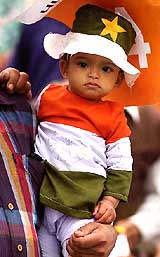 A young cricket buff waits for the rain to stop at the PCA Stadium in Mohali on Wednesday