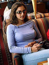 Teenage tennis sensation Sania Mirza follows the Indo-Pak Test match on her mobile phone in Mumbai on Friday