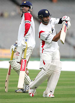 Sachin Tendulkar plays a stroke as Sourav Ganguly looks on during a practice session in Kolkata