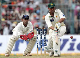 Younis Khan executes a shot as Dinesh Kaarthick watches during the second day�s play of the second Test in Kolkata on Thursday