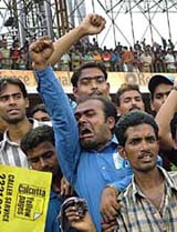 Angry cricket fans protest umpire Steve Bucknor's verdict that went against Sachin Tendulkar on the third day of the second Test in Kolkata on Friday