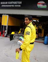 Narain Karthikeyan in the pits before a practice session for the Malaysian Grand Prix at Sepang circuit, outside Kuala Lumpur