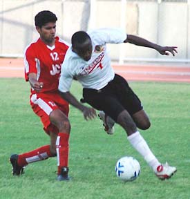 East Bengal�s E.C. Jeremiah being checked by JCT defender Daljit Singh in a National Football League match at Ludhiana�s Guru Nanak Stadium on Tuesday. East Bengal won the match 1-0