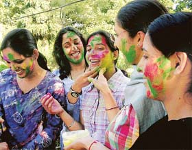 Punjabi University students play with gulal on the university campus in Patiala