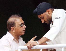 Former Indian captain Sunil Gavaskar gives tips to Harbhajan Singh during the tea break in Bangalore on Friday