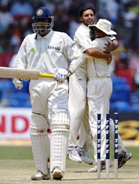 Pakistan�s Shahid Afridi celebrates with Younis Khan after taking the wicket of Anil Kumble on the fourth day of the third Test in Bangalore 
