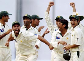 Pakistan cricketers celebrate their victory in the third Test against India in Bangalore on Monday