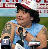 Argentine soccer legend Diego Maradona shows a tattoo of Latin-American rebel Che Ghevara