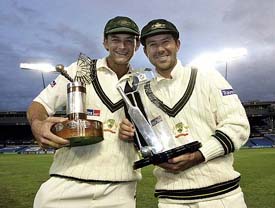 Australia's cricket player Adam Gilchrist and captain Ricky Ponting pose with their trophies at Eden Park