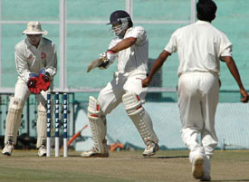Punjab�s Reetinder Sodhi plays a cut shot off Madan Yadav of Railways on the second day of the Ranji Trophy Elite Group final at the PCA Stadium in Mohali 