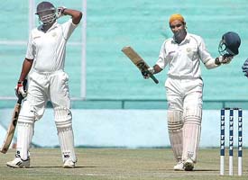 Punjab�s Pankaj Dharmani acknowledges the applause after completing his century against Railways 