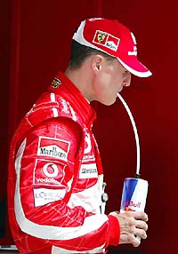 Ferrari�s Michael Schumacher sips a drink after the first qualifying session of the Bahrain Formula One Grand Prix 