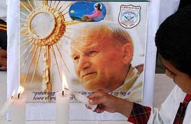 Schoolchildren pray for the departed soul of Pope John Paul II at a school in Amritsar on Sunday