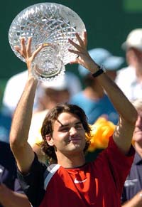 Roger Federer of Switzerland holds the trophy after defeating Rafael Nadal of Spain in the final of the Nasdaq-100 Open in Key Biscayne, Florida
