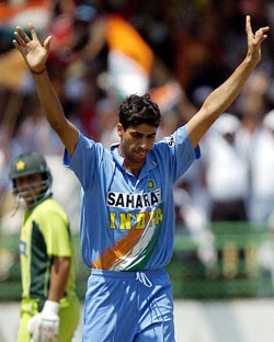 Ashish Nehra celebrates the dismissal of Shahid Afridi as Salman Butt looks on during the second ODI match in Visakhapatnam on Tuesday