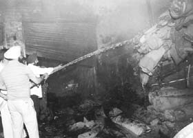 Firemen extinguishing the fire that broke into a godown of a tent house located in Caliber Market in Rajpura