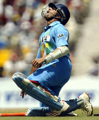 Sachin Tendulkar sits on the ground after a cramp in his leg during the fourth one-day international between India and Pakistan
