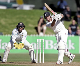Lou Vincent of New Zealand hits a shot as Kumara Sangakkara of Sri Lanka looks on during the second day�s play of the second Test in Wellington
