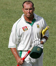South African all-rounder Jacques Kallis holds a stump as he walks back to the dressing room following his team's victory over the West Indies
