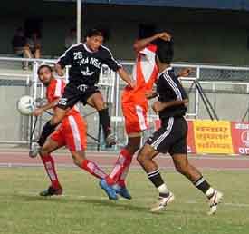 Fransa Pax FC�s Saikhom Singh leaps into the air to clear the ball as JCT�s Jaswinder Singh looks on in the ninth National Football League match at Ludhiana�s Guru Nanak Stadium on Friday