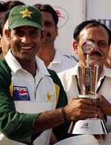 Pakistan cricketer Naved-ul-Hasan Rana holds Man of the Series trophy after the sixth one-day cricket match between India and Pakistan