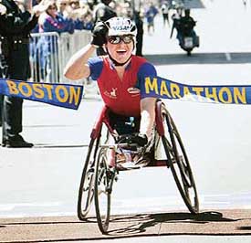 Defending Boston Marathon women's wheelchair champion Cheri Blauwet of the USA crosses the finish line to win the 109th Boston Marathon in a time of one hour