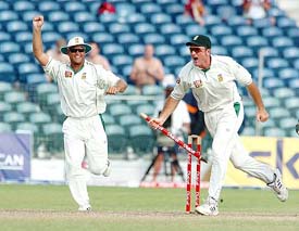 South Africa�s Jacques Kallis  and captain Graeme Smith celebrate after beating the West Indies on the fourth day of the third Test at Kensington Oval in Bridgetown