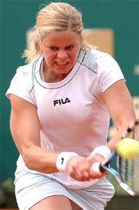 Kim Clijsters of Belgium returns the ball to Tatiana Perebiynis of Ukraine during their first round match at the WTA J&S Cup in Warsaw, Poland