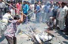 Members of the Punjab Beopar Mandal burn an effigy of VAT in Amritsar on Friday. 