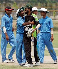 Pakistani blind cricketer Masood Jan congratulates an Indian player after India won the second match