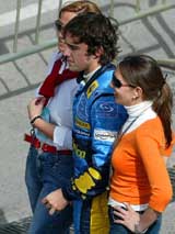 Renault Formula One driver Fernando Alonso of Spain poses with fans