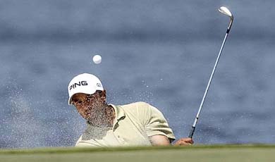 Arjun Atwal of India hits from the trap guarding the ninth green