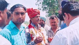 A retired employee returning from his farewell party is surrounded by the staff of a liquor contractor near Nangal Bhoor village on the Mukerian-Pathankot road.